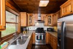The kitchen has nice stainless appliances and is stocked with dishes, glassware, and utensils